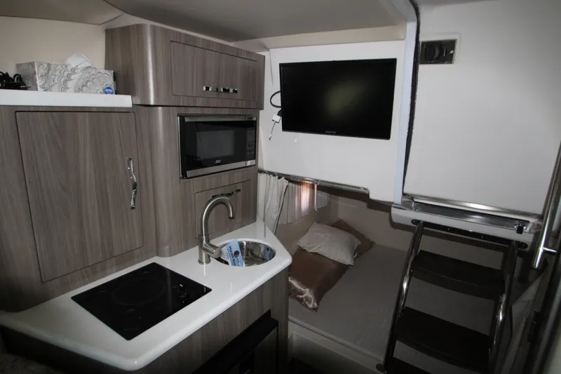 Slide: The Image of Interior of 2022 Regal 28 Express boat with kitchenette and TV. - 4