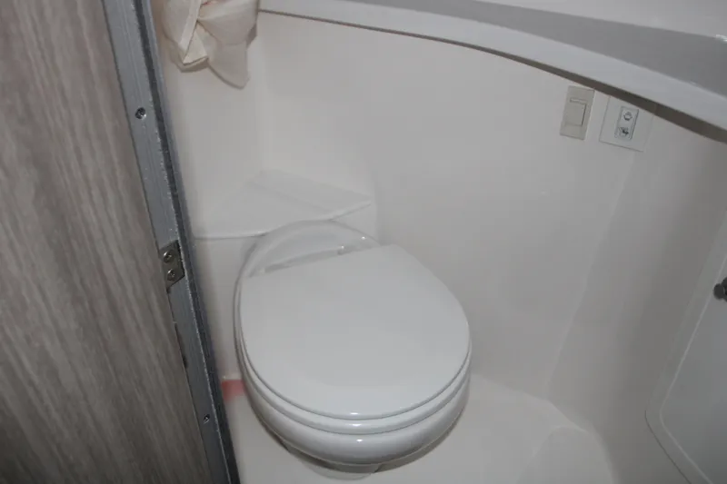 Slide: The Image of 2022 Regal 28 Express boat bathroom with compact toilet. - 40