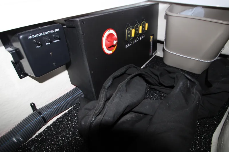 Slide: The Image of 2022 Regal 28 Express boat interior with control box and storage area. - 44