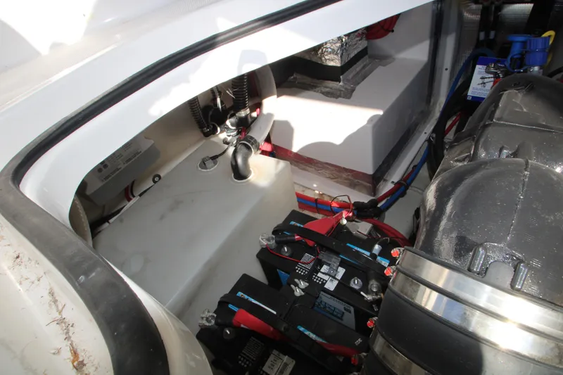 Slide: The Image of 2022 Regal 28 Express engine compartment with batteries and wiring. - 47