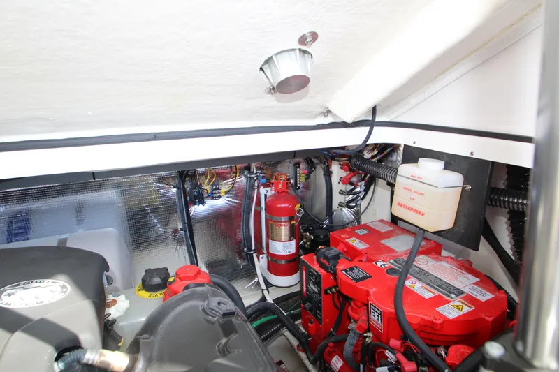 Slide: The Image of 2022 Regal 28 Express engine compartment with fire extinguisher and battery system. - 48