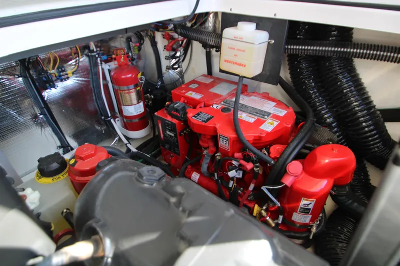 Slide: The Image of Engine compartment of 2022 Regal 28 Express boat with red components and fire extinguisher. - 49