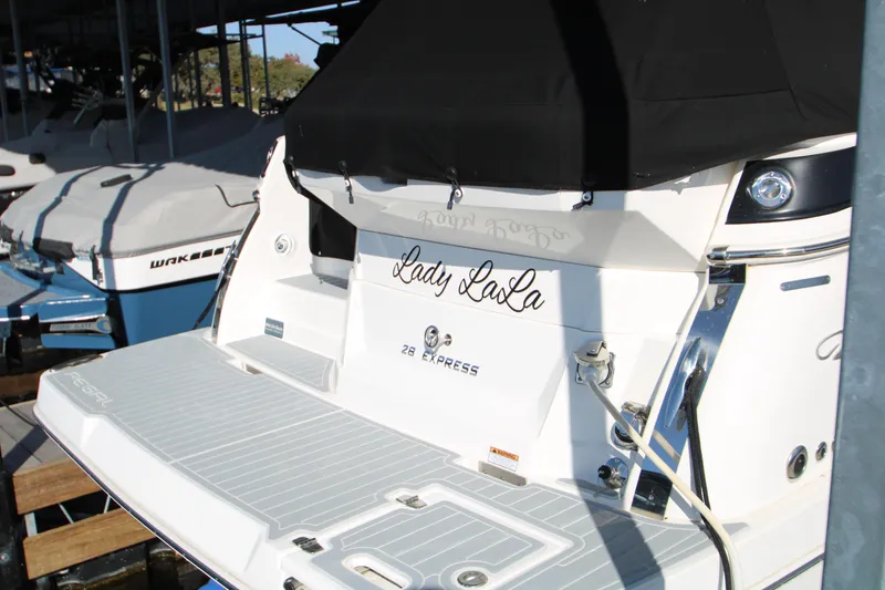 Slide: The Image of 2022 Regal 28 Express boat named "Lady LaLa" docked in marina. - 5