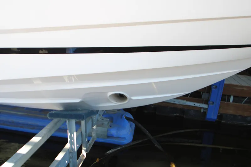 Slide: The Image of 2022 Regal 28 Express boat hull on a lift, showcasing sleek design and craftsmanship. - 6