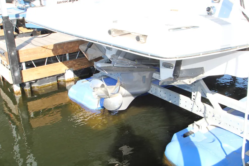 Slide: The Image of 2022 Regal 28 Express boat docked, showing stern and propeller in water. - 7