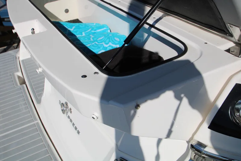 Slide: The Image of 2022 Regal 28 Express boat storage compartment with blue towel. - 9