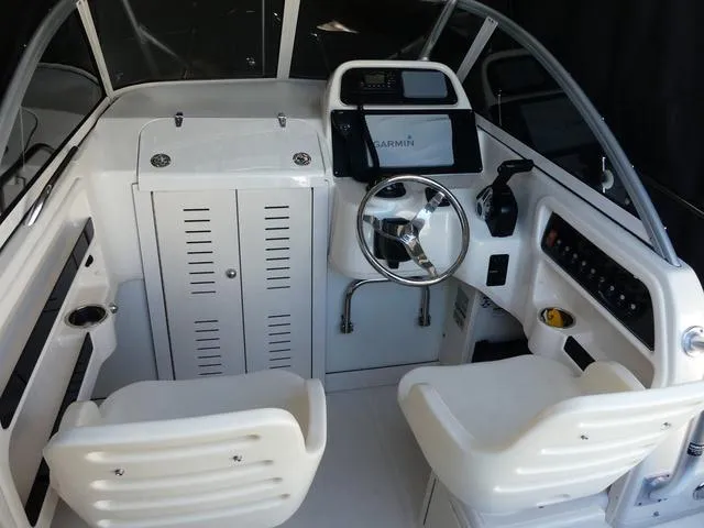 Slide: The Image of 2022 Grady-White Adventure 208 boat interior with steering wheel and seating. - 10