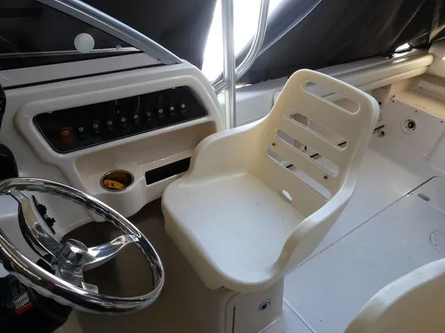 Slide: The Image of Interior of 2022 Grady-White Adventure 208 boat, featuring helm and captain's chair. - 14