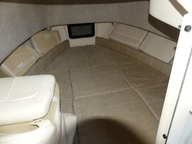 Slide: The Image of Interior cabin of 2022 Grady-White Adventure 208 boat, featuring beige upholstery and compact design. - 16