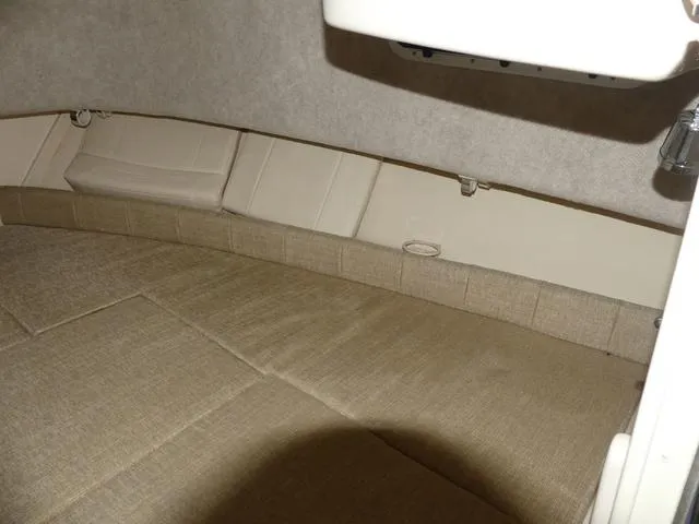 Slide: The Image of Interior cabin of 2022 Grady-White Adventure 208 boat, featuring beige upholstery. - 17