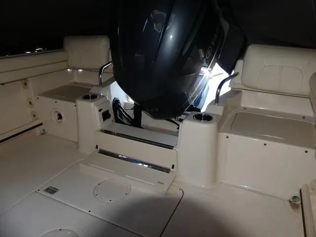 Slide: The Image of 2022 Grady-White Adventure 208 boat interior with engine and seating area. - 20