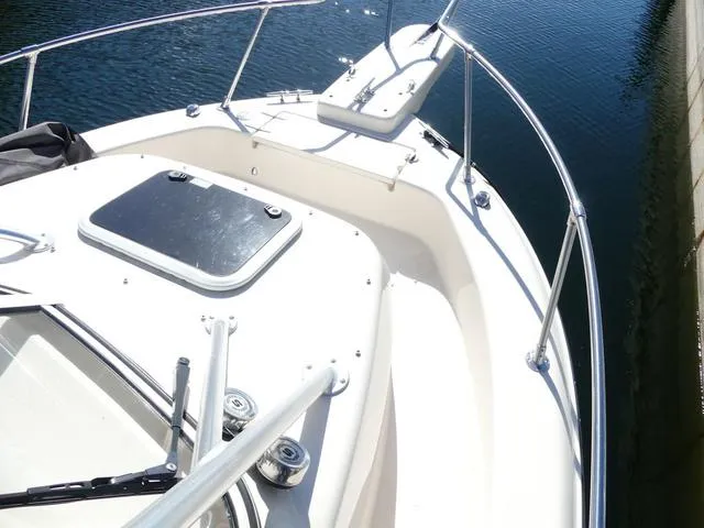 Slide: The Image of 2022 Grady-White Adventure 208 boat deck with railing on calm water. - 24