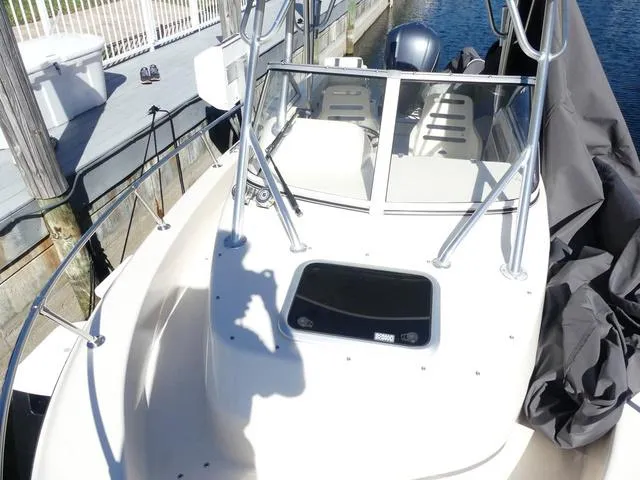 Slide: The Image of 2022 Grady-White Adventure 208 boat docked, featuring sleek design and spacious deck. - 26