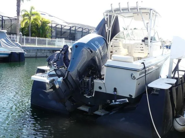 Slide: The Image of 2022 Grady-White Adventure 208 boat with Yamaha outboard motor docked in marina. - 6