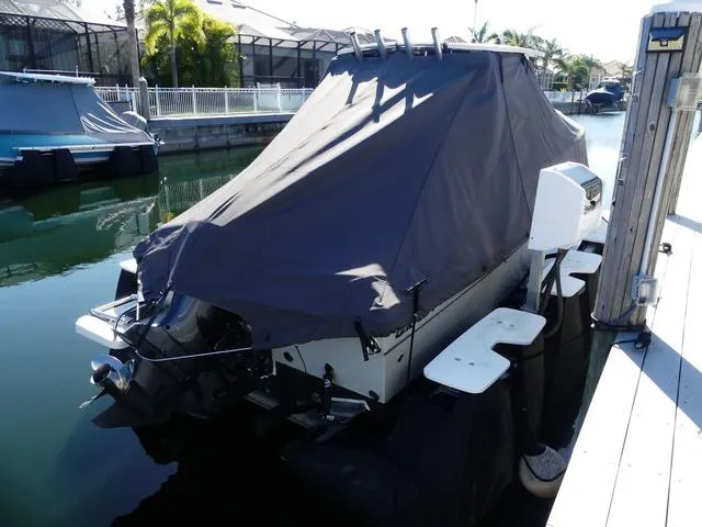 Slide: The Image of Covered 2022 Grady-White Adventure 208 boat docked in a marina. - 8