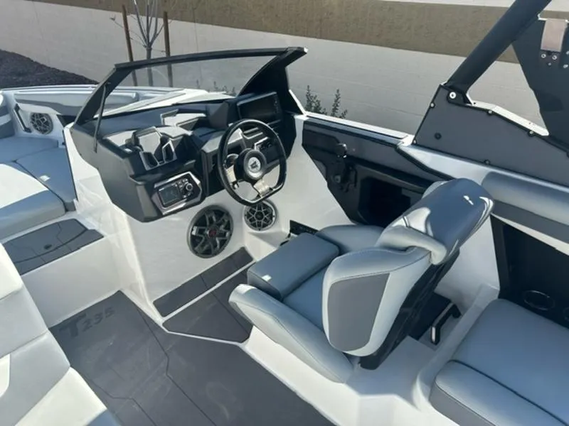 Slide: The Image of 2023 Axis T235 boat interior with modern dashboard and seating. - 12