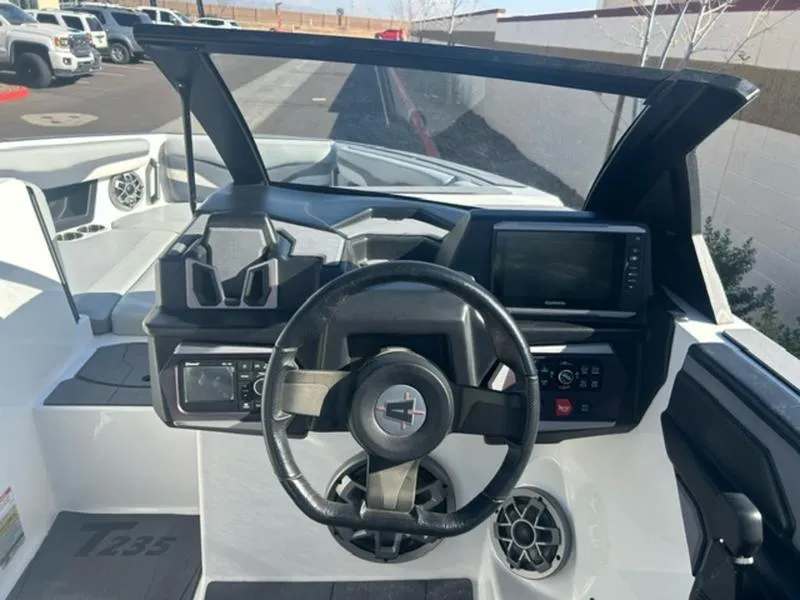 Slide: The Image of 2023 Axis T235 boat dashboard with steering wheel and navigation display. - 13
