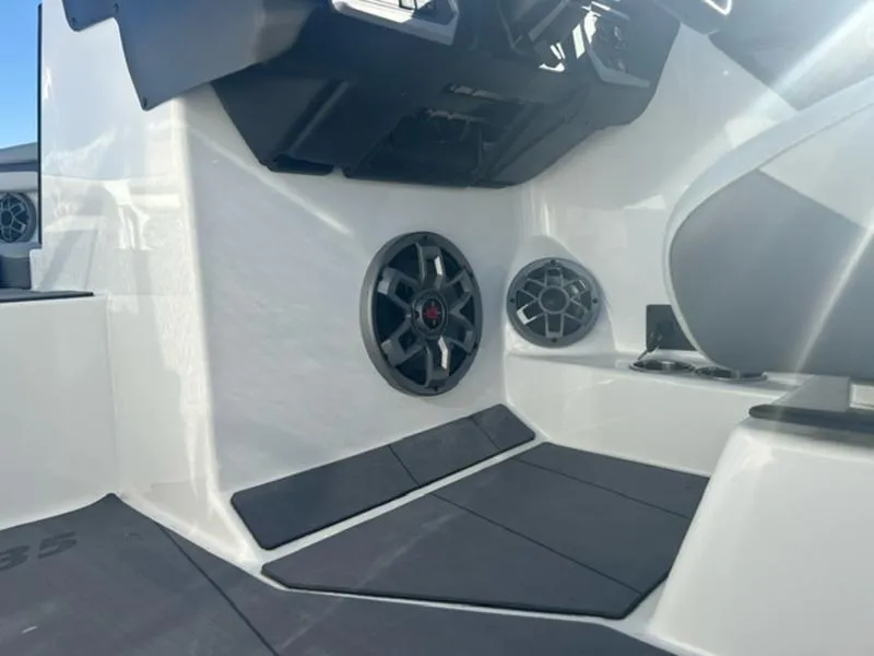 Slide: The Image of 2023 Axis T235 boat interior with speakers and seating area. - 14