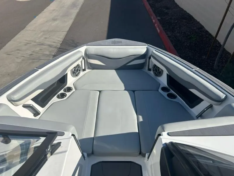 Slide: The Image of 2023 Axis T235 boat interior with gray seating and built-in speakers. - 15