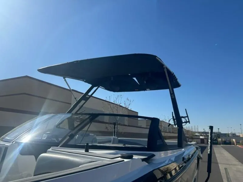 Slide: The Image of 2023 Axis T235 boat with wakeboard tower under clear blue sky. - 7