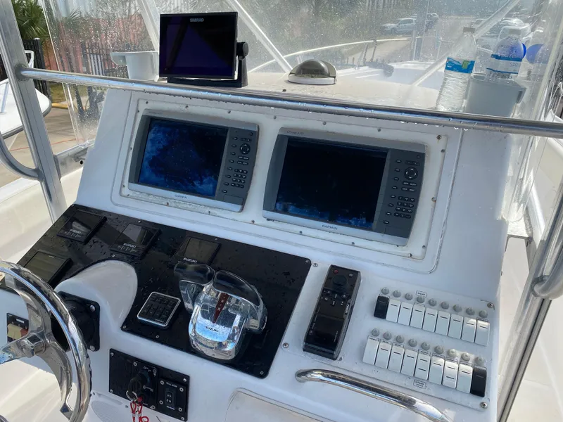 Slide: The Image of Control panel of a 2000 Donzi 35 ZF Open boat with navigation screens. - 13