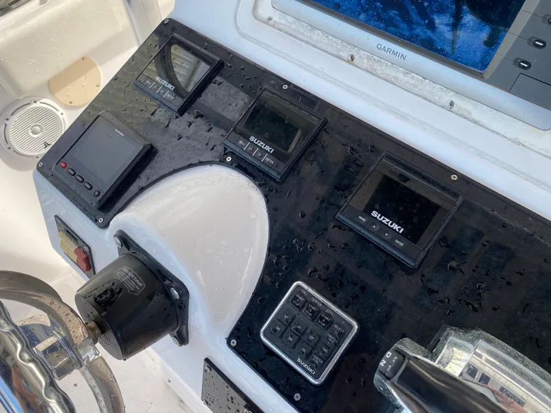 Slide: The Image of Dashboard of a 2000 Donzi 35 ZF Open boat with Suzuki controls and Garmin display. - 16