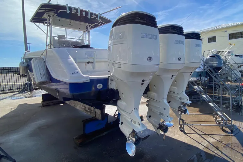 Slide: The Image of 2000 Donzi 35 ZF Open boat with triple outboard engines on display. - 3