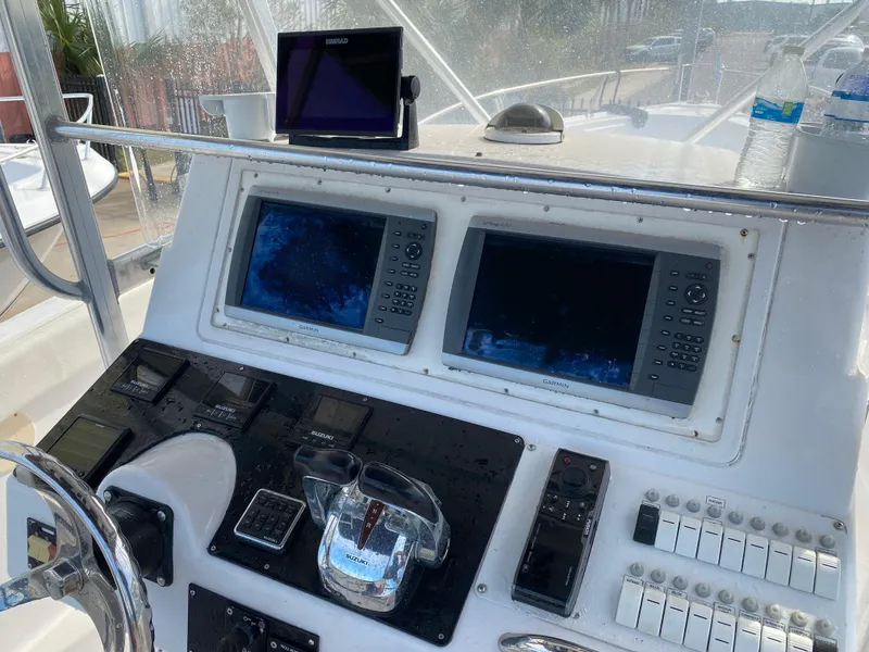 Slide: The Image of Control panel of a 2000 Donzi 35 ZF Open boat with navigation screens. - 4