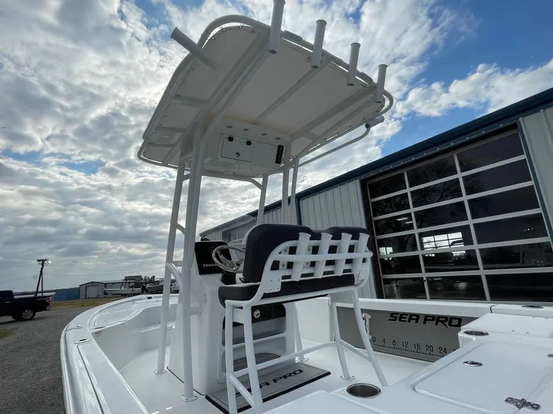 Slide: The Image of 2025 Seapro 230 boat with T-top, docked under cloudy sky. - 9