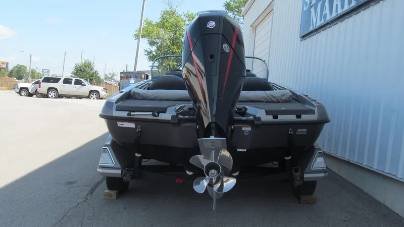 Slide: The Image of 2025 Ranger 212LS boat with powerful outboard motor, parked outdoors. - 4