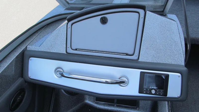 Slide: The Image of 2025 Ranger 212LS boat dashboard with storage compartment and control panel. - 8
