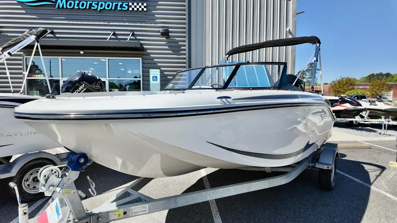 Slide: The Image of 2025 Bayliner M17 boat on trailer outside dealership. - 6