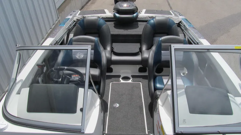Slide: The Image of 2025 Ranger 212LS boat interior with open windshield and seating. - 10