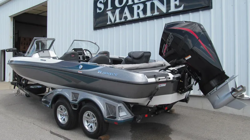 Slide: The Image of 2025 Ranger 212LS boat with outboard motor on trailer at marine store. - 3