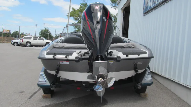 Slide: The Image of 2025 Ranger 212LS boat rear view with outboard motor in parking lot. - 4