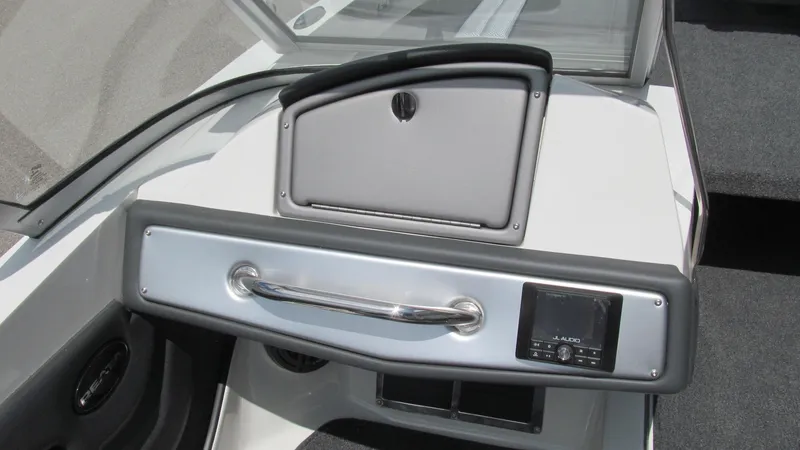 Slide: The Image of 2025 Ranger 212LS boat dashboard with storage compartment and control panel. - 7