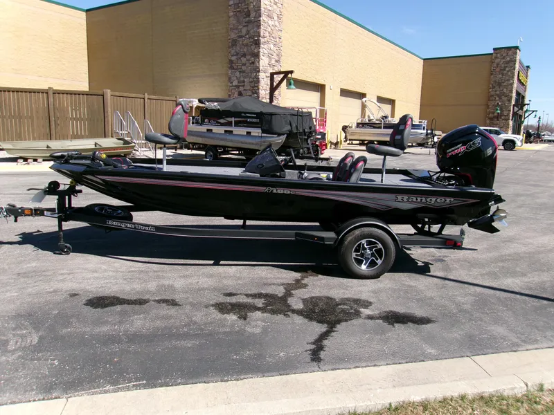 Slide: The Image of 2025 Ranger RT188C fishing boat parked outdoors on a trailer. - 2