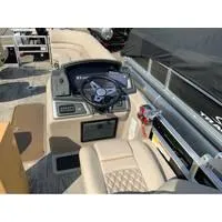 Slide: The Image of 2025 Ranger Reata 223FC boat interior with steering wheel and beige seating. - 11