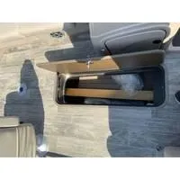 Slide: The Image of 2025 Ranger Reata 223FC boat storage compartment with wooden flooring. - 13