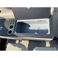 Slide: The Image of 2025 Ranger Reata 223FC boat console with cup holders and storage compartment. - 4