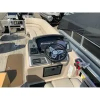 Slide: The Image of 2025 Ranger Reata 223FC boat dashboard with steering wheel and controls. - 5
