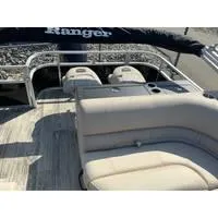 Slide: The Image of 2025 Ranger Reata 223FC boat interior with beige seating and sleek design. - 8