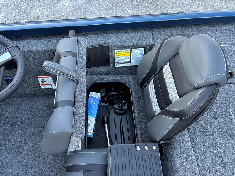 Slide: The Image of 2025 Ranger RT178C boat interior with storage compartment and gray seating. - 19