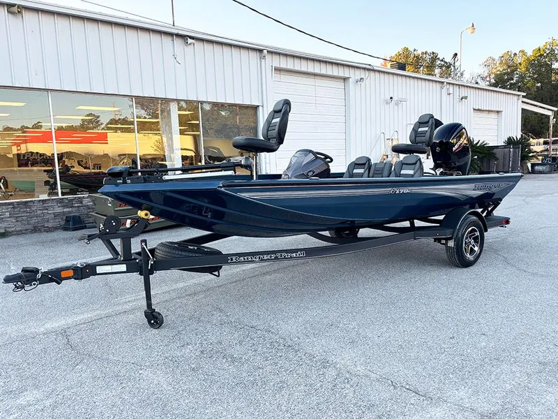 Slide: The Image of 2025 Ranger RT178C fishing boat on trailer outside dealership. - 2