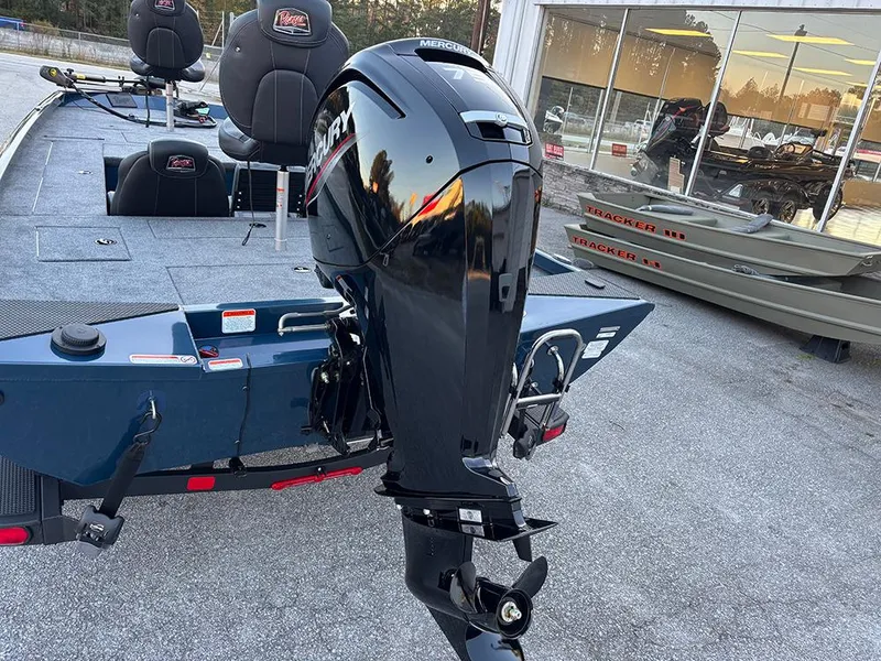 Slide: The Image of 2025 Ranger RT178C boat with Mercury outboard motor, parked outdoors. - 29