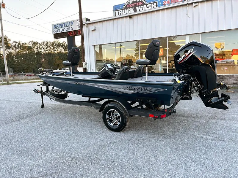 Slide: The Image of 2025 Ranger RT178C fishing boat with Mercury engine parked outside dealership. - 7