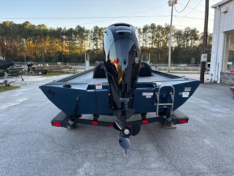 Slide: The Image of 2025 Ranger RT178C boat with outboard motor, parked on a trailer in a lot. - 8