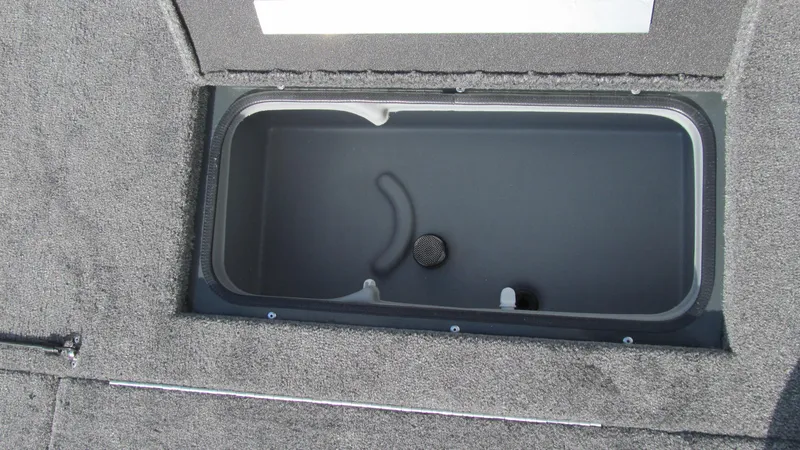 Slide: The Image of 2025 Ranger RT188C boat storage compartment with carpeted interior. - 12
