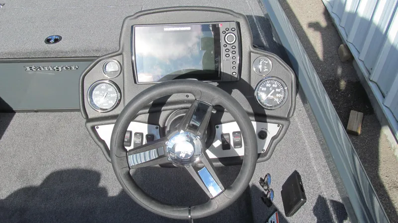 Slide: The Image of 2025 Ranger RT188C boat dashboard with steering wheel and electronic display. - 6