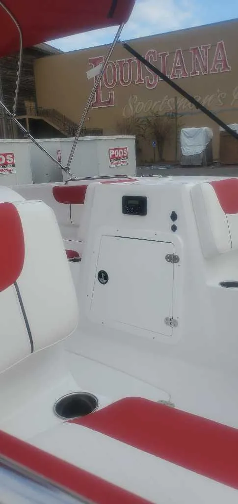 Slide: The Image of Open storage compartment on 2025 Tahoe 2150 boat, featuring a caution label. - 6